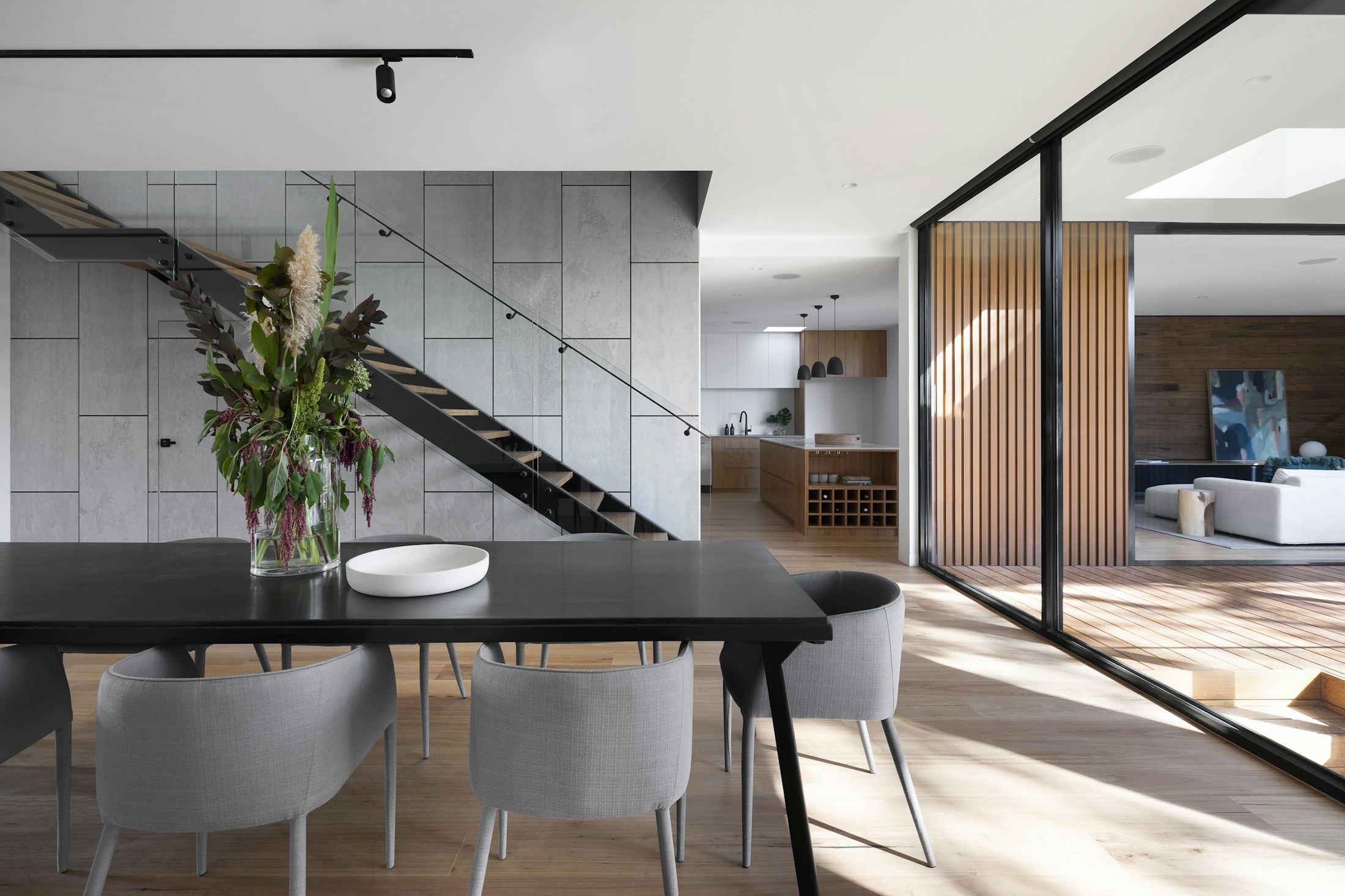Sunlit contemporary interior with natural wood and architectural detailing; illustrative photograph